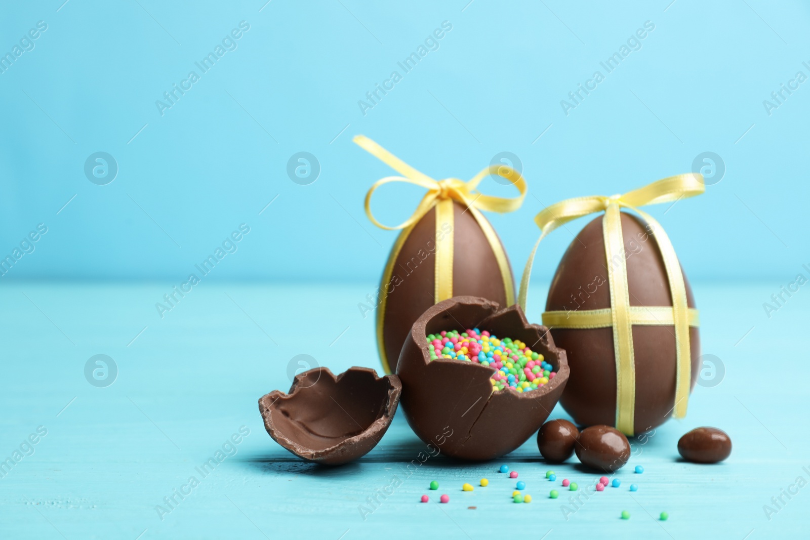 Photo of Composition with chocolate Easter eggs on table. Space for text