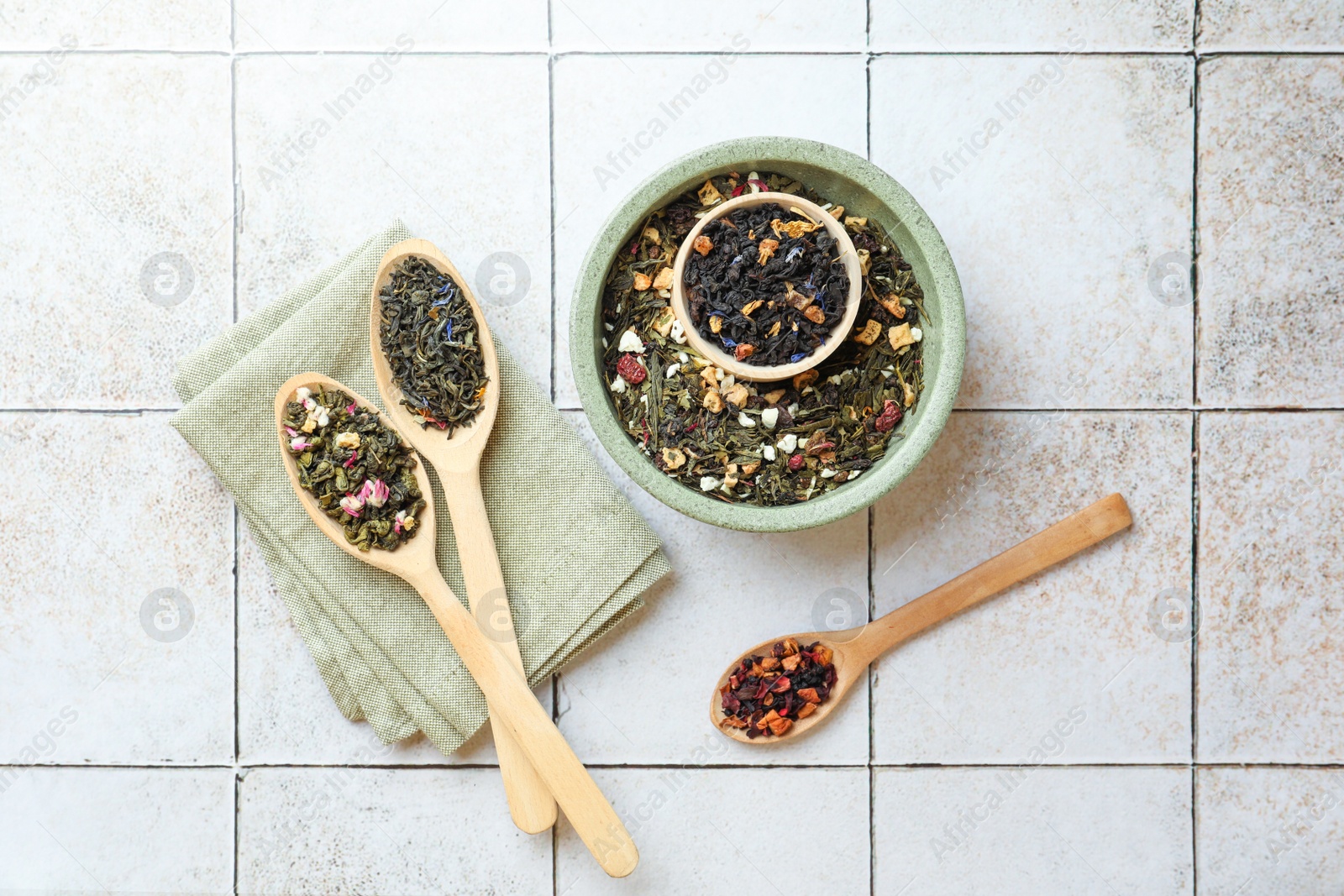 Photo of Many different herbal teas on white tiled surface, flat lay