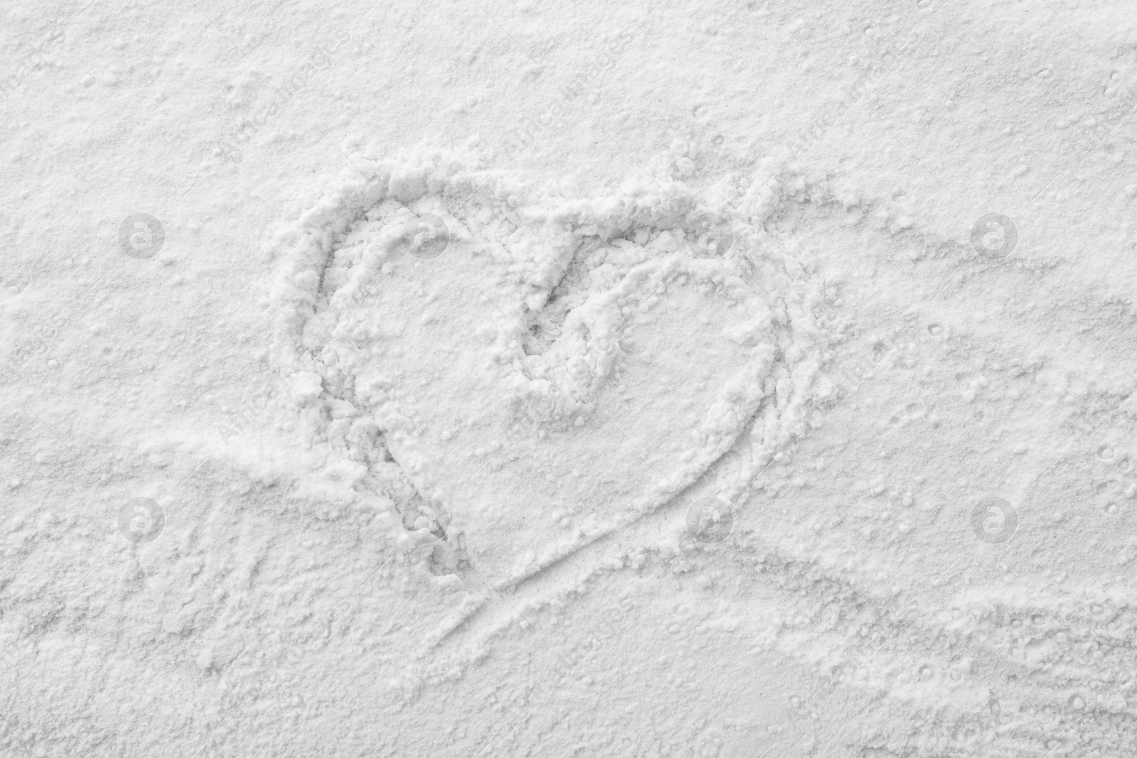 Photo of Heart drawn on baking powder, top view