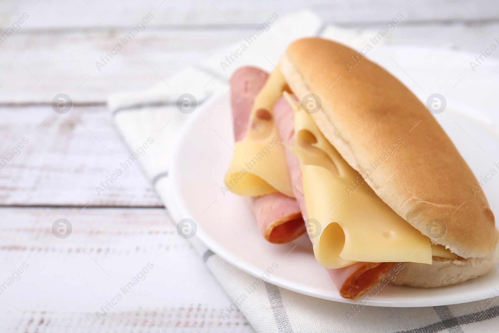 Photo of Delicious sandwich with ham and cheese on white table, closeup. Space for text