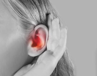 Woman suffering from earache, closeup. Black and white tone 