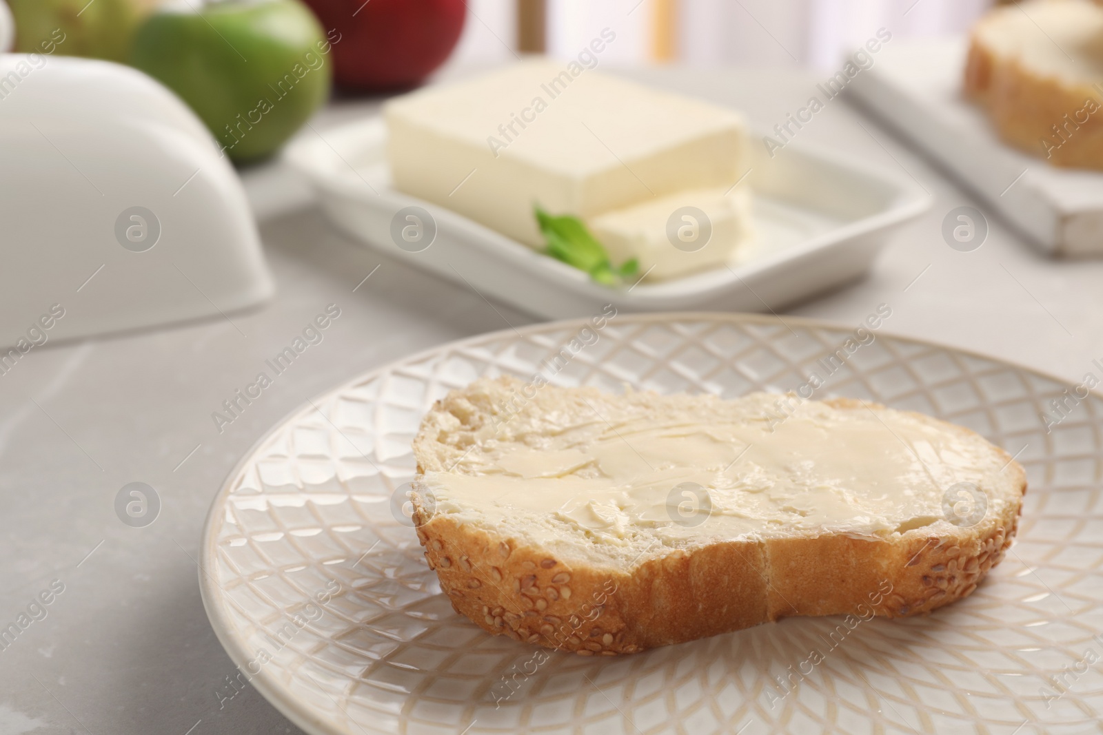 Photo of Fresh bread with tasty butter on plate