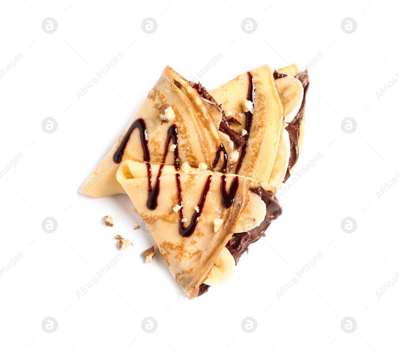 Photo of Delicious thin pancakes with chocolate spread, banana and nuts on white background, top view