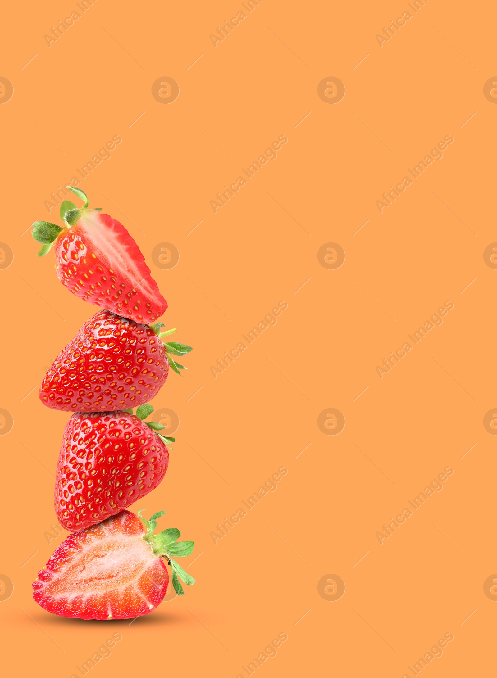 Image of Stack of fresh strawberries on orange background, space for text