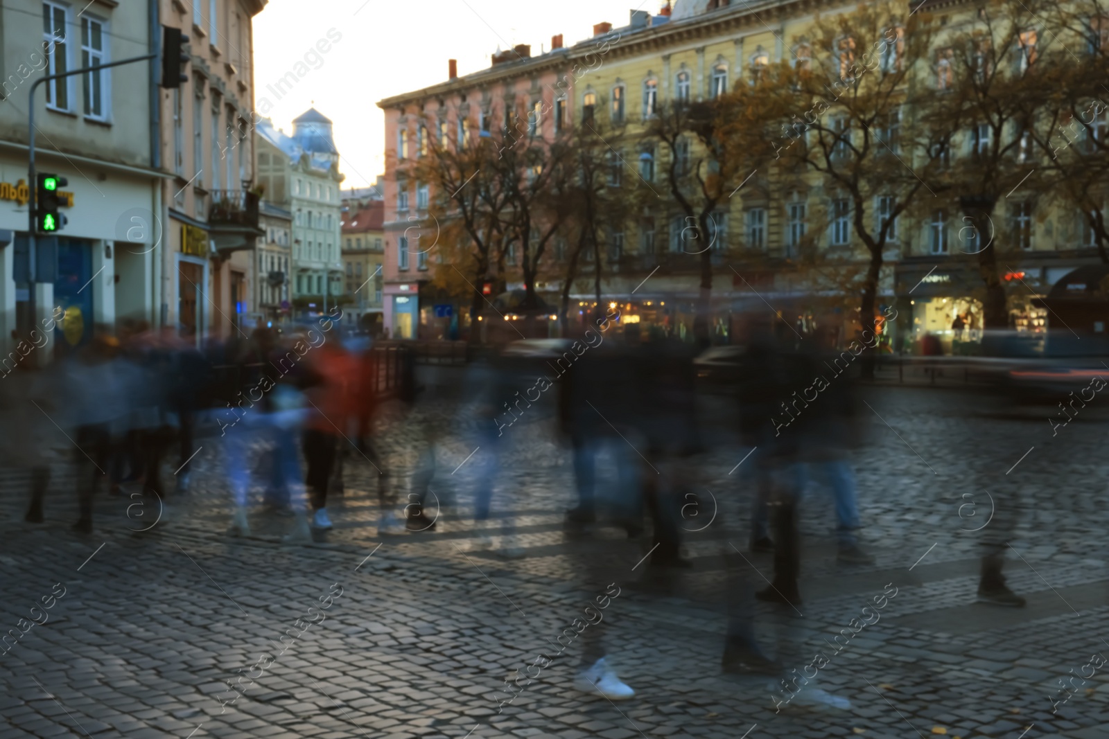 Photo of Blurred view of people crossing street in city