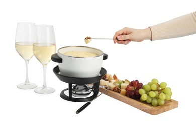 Photo of Woman dipping walnut into fondue pot with melted cheese on white background, closeup