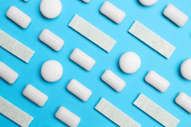 Photo of White bubble gums on blue background, flat lay