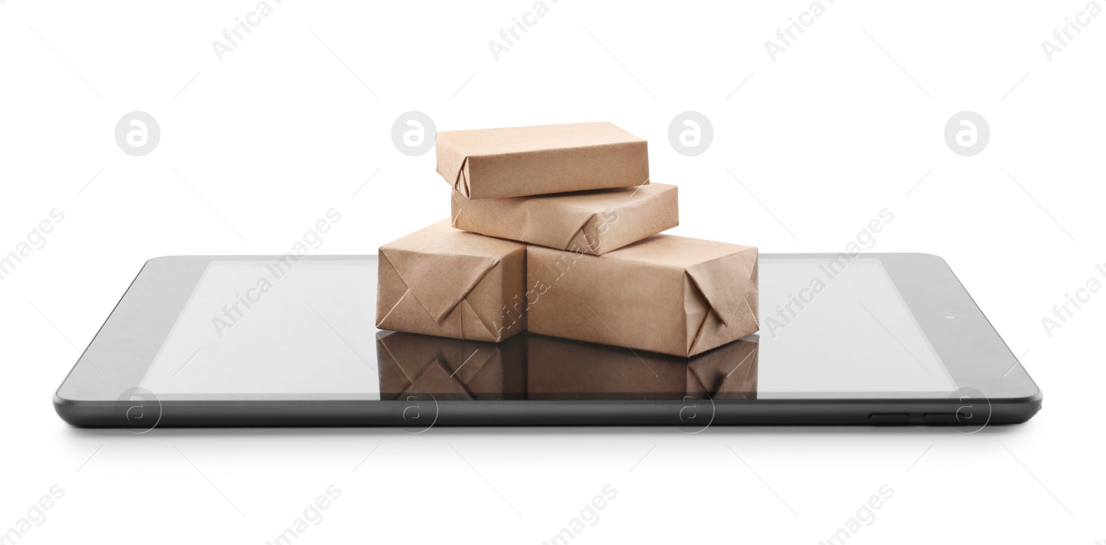Photo of Internet shopping. Small boxes and modern tablet on white background