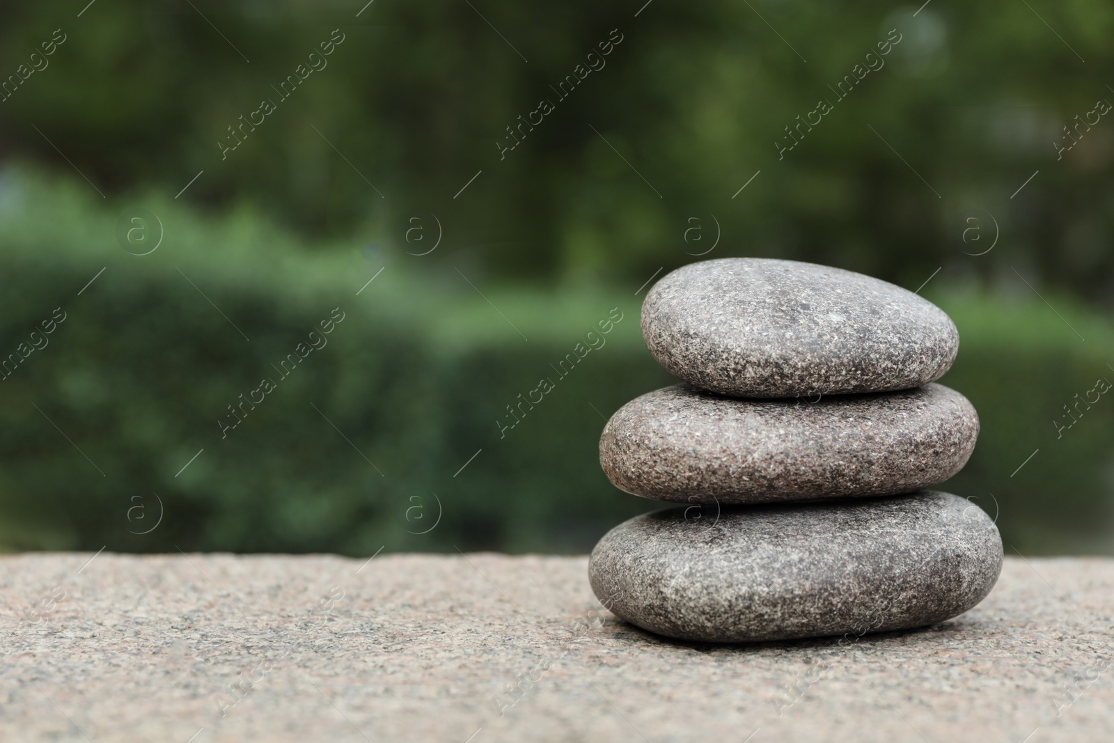 Photo of Stack of spa stones outdoors, closeup. Space for text