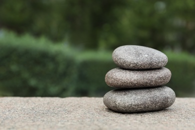 Stack of spa stones outdoors, closeup. Space for text