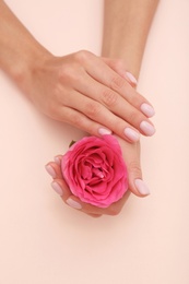 Photo of Closeup view of woman with rose on color background. Spa treatment