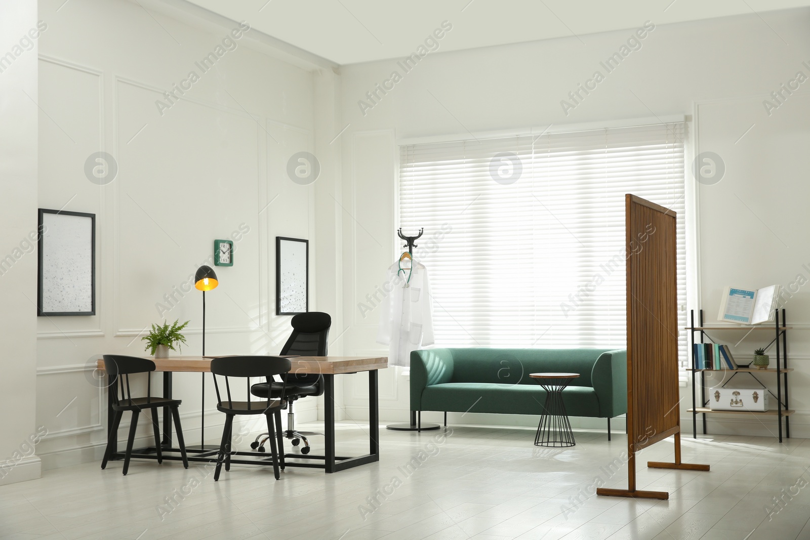 Photo of Modern medical office interior with doctor's workplace and sofa