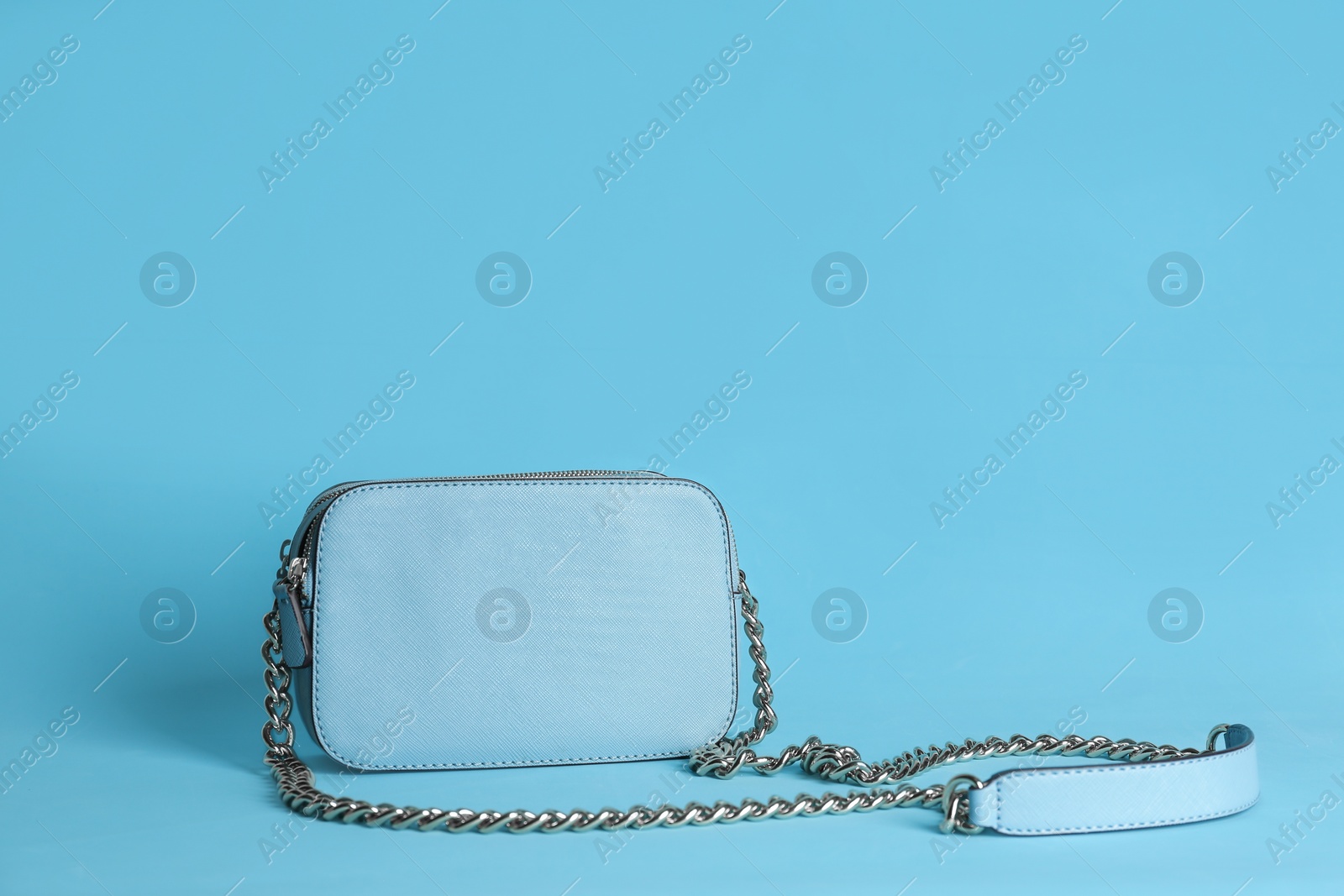 Photo of Stylish woman's bag on light blue background