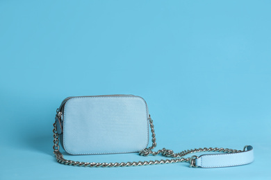 Photo of Stylish woman's bag on light blue background