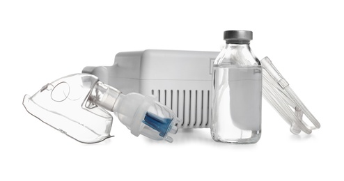 Photo of Modern nebulizer with face mask and liquid medicine on white background. Inhalation equipment