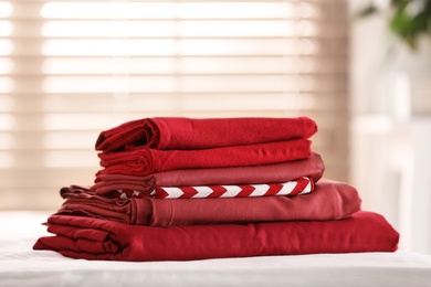 Photo of Clean color folded linens on bed indoors