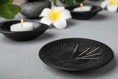 Plate with needles for acupuncture on table