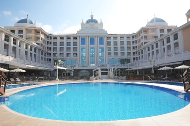 Photo of Beautiful view of hotel with swimming pool at resort