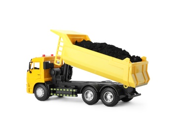 Yellow toy tipper truck with coal isolated on white