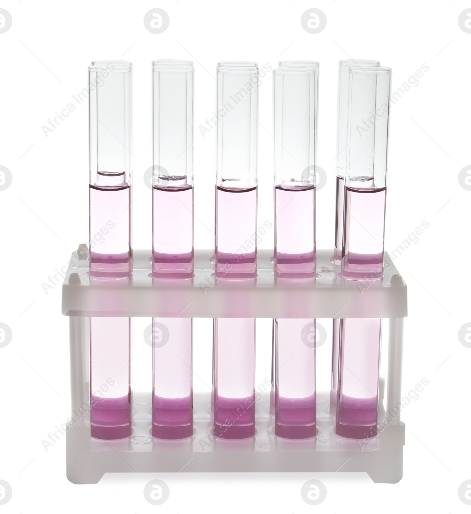 Photo of Test tubes with pink liquid on white background