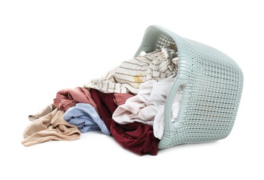 Photo of Overturned laundry basket full of clothes isolated on white