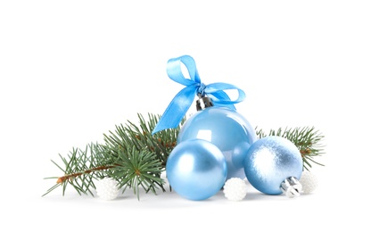 Beautiful Christmas balls and fir branch on white background