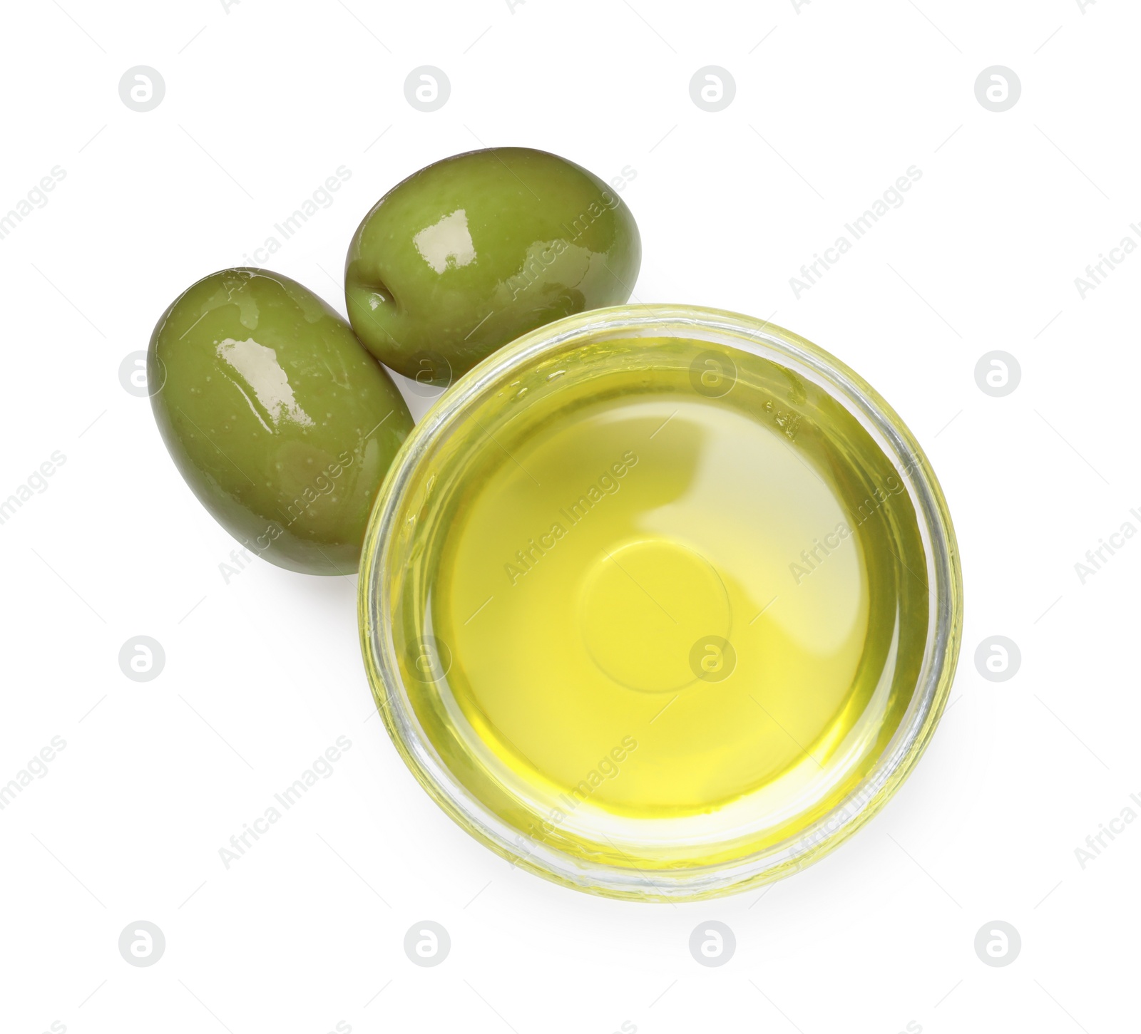 Photo of Cooking oil in bowl and olives on white background, top view