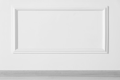 Photo of Beautiful white wall with molding in clean empty room