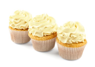 Photo of Tasty vanilla cupcakes with cream isolated on white