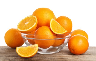 Fresh oranges in bowl on wooden table against white background