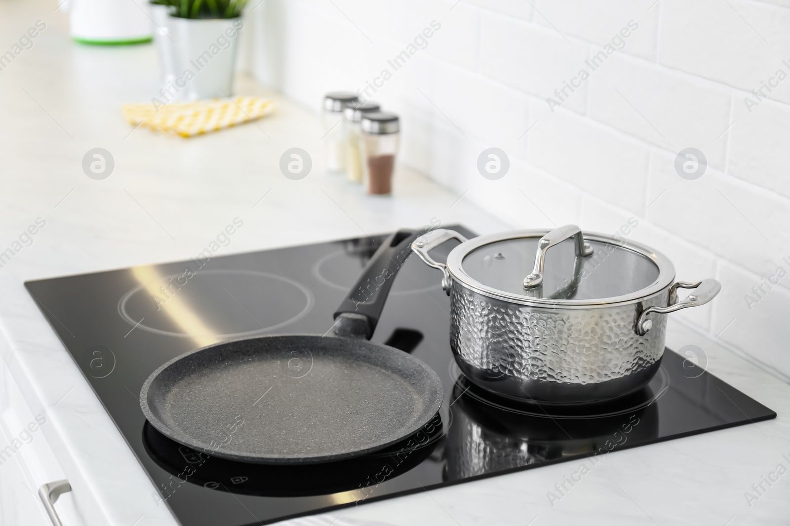 Photo of Pot and frying pan on stove in kitchen