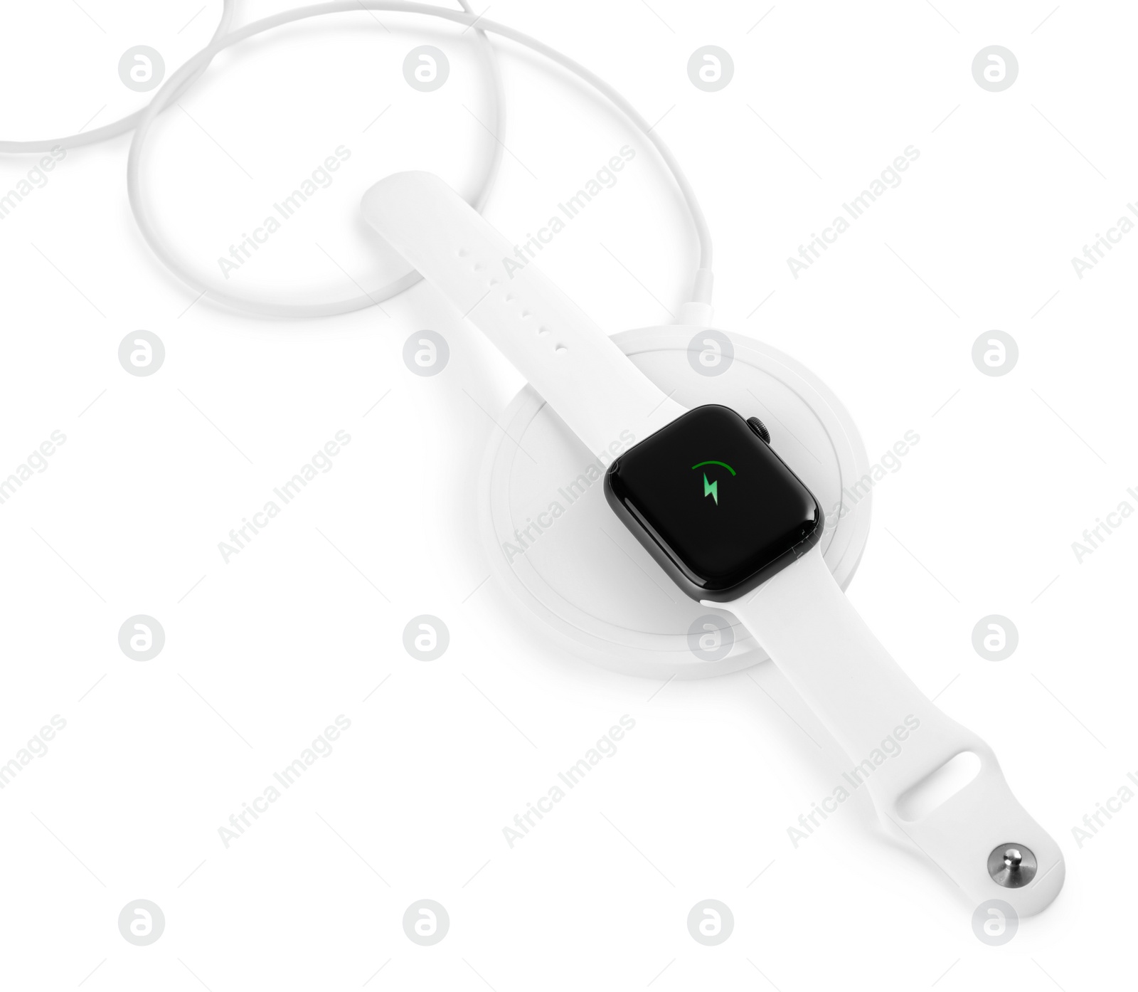 Photo of Smartwatch charging with wireless pad isolated on white, above view