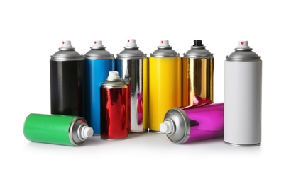 Photo of Cans of different spray paints on white background