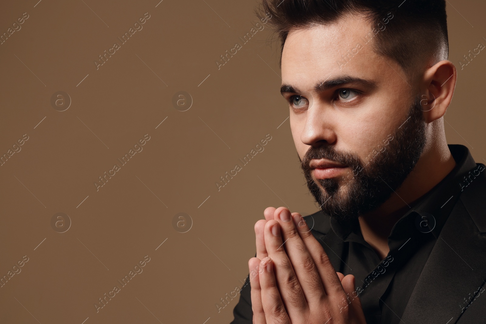 Photo of Handsome bearded man on light brown background. Space for text