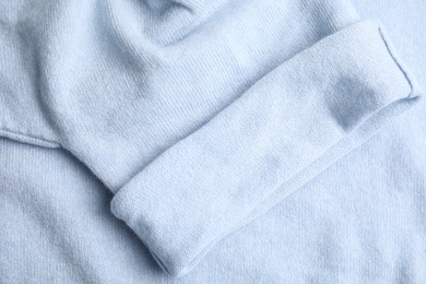 Photo of Warm cashmere sweater as background, top view