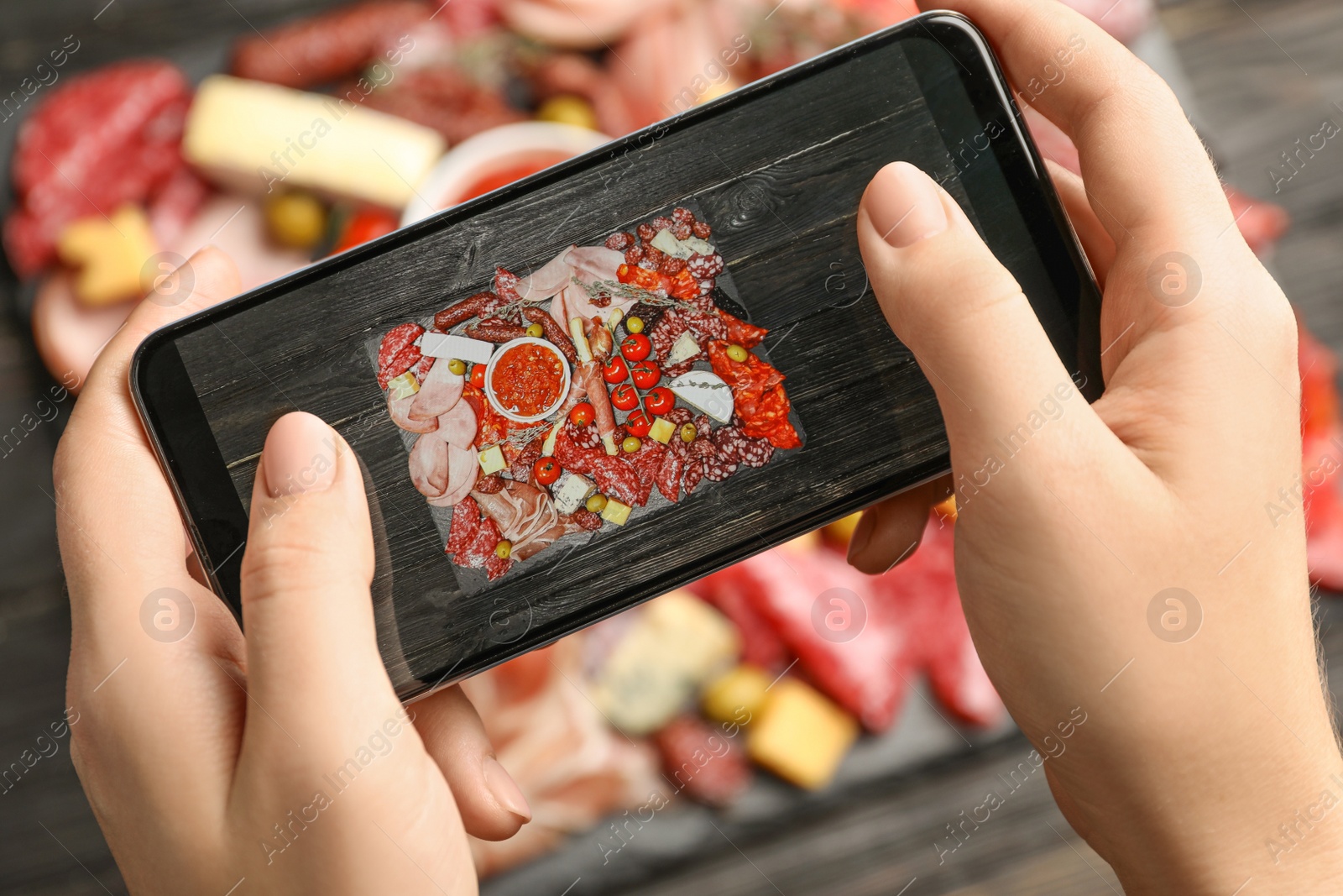 Photo of Blogger taking picture of food at table, closeup