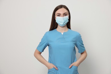 Nurse with medical mask on white background