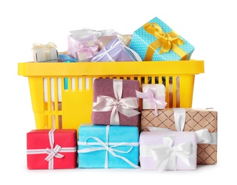 Yellow shopping basket with different gifts on white background