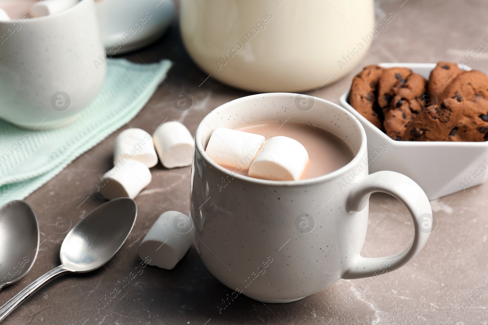 Photo of Hot cocoa drink with marshmallows in cup on table