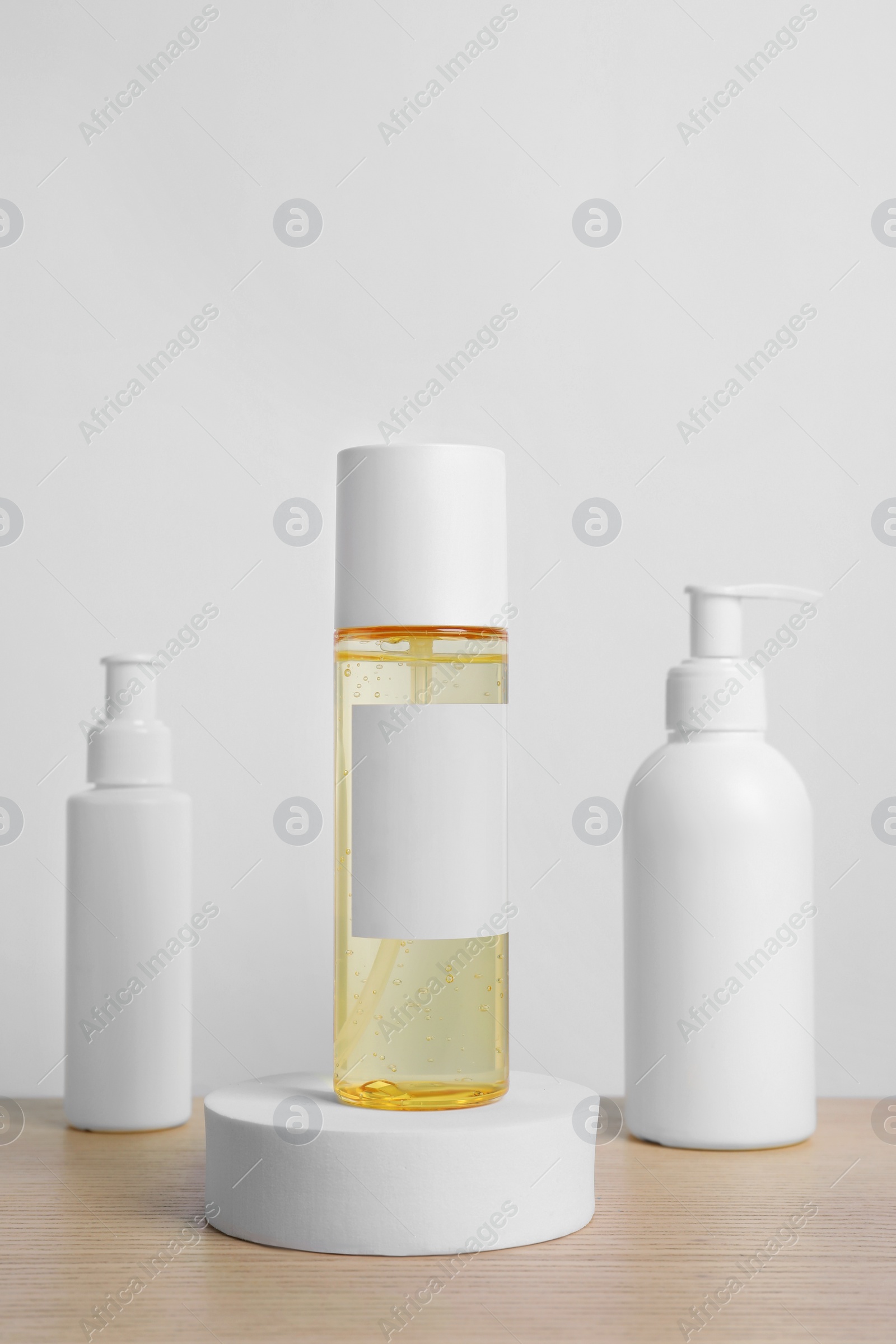 Photo of Bottles of cosmetic products on wooden table