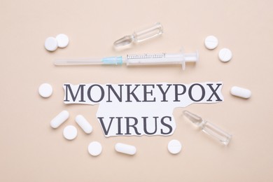 Words Monkeypox Virus, syringe, vials and pills on beige background, flat lay