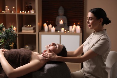 Photo of Spa therapy. Beautiful young woman lying on table during massage in salon