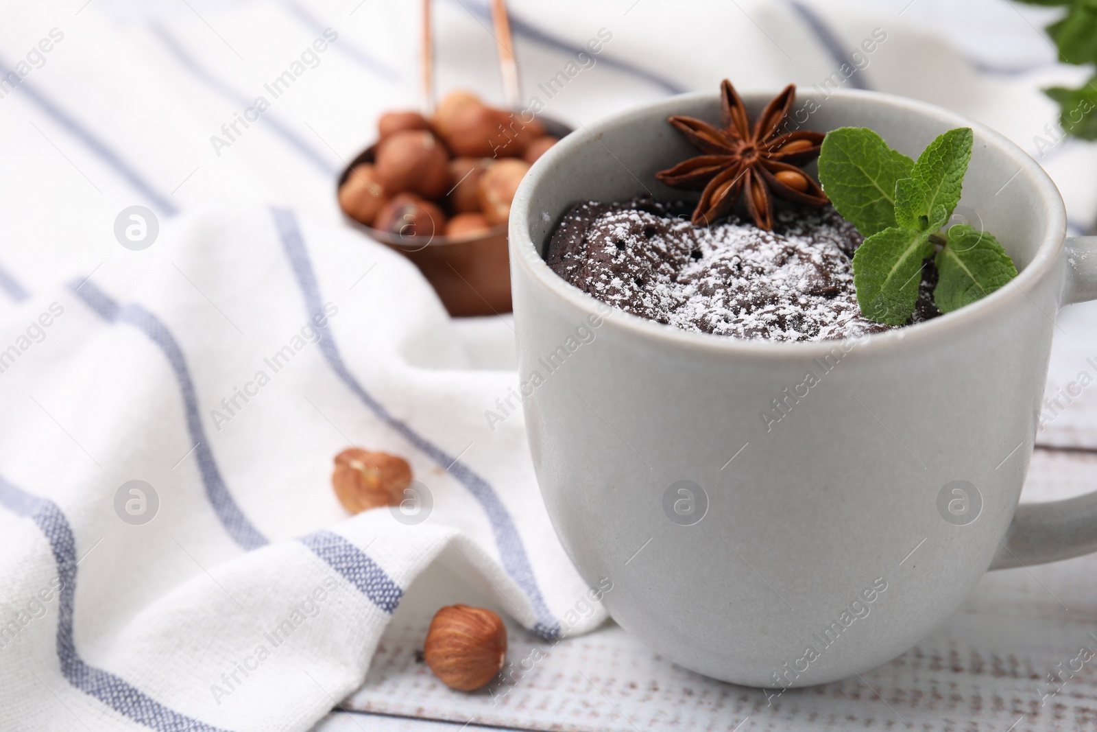 Photo of Tasty chocolate mug pie on white table, space for text. Microwave cake recipe