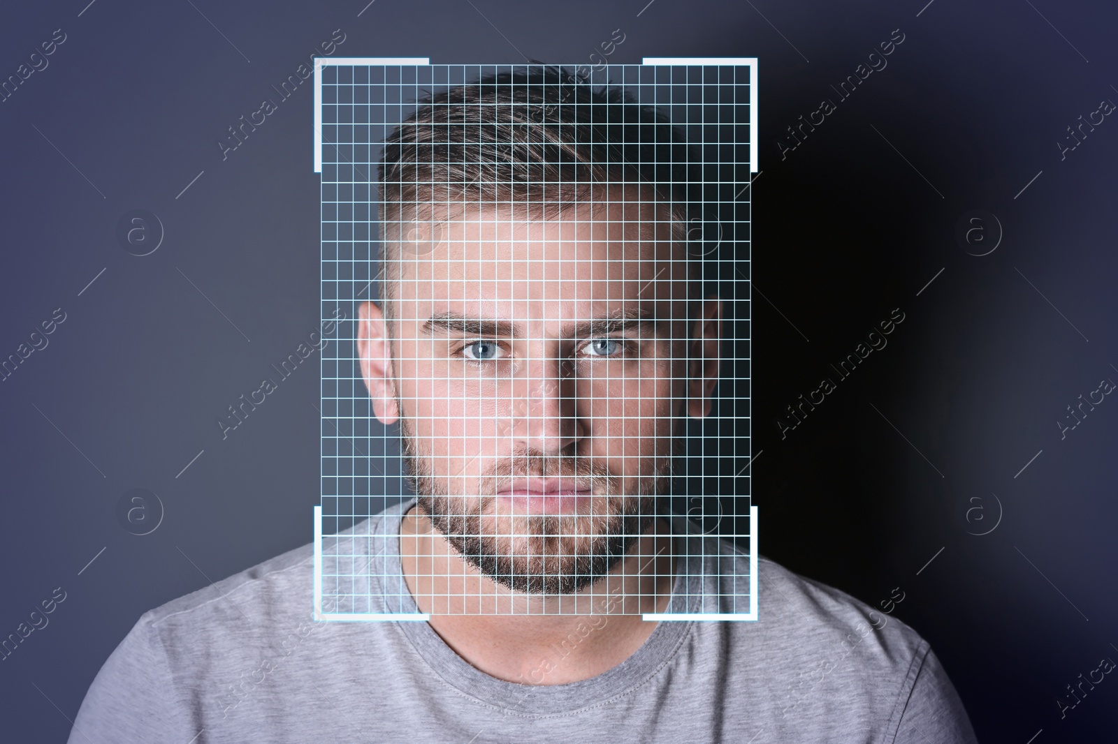 Image of Facial recognition system. Young man with scanner frame and digital grid on dark background