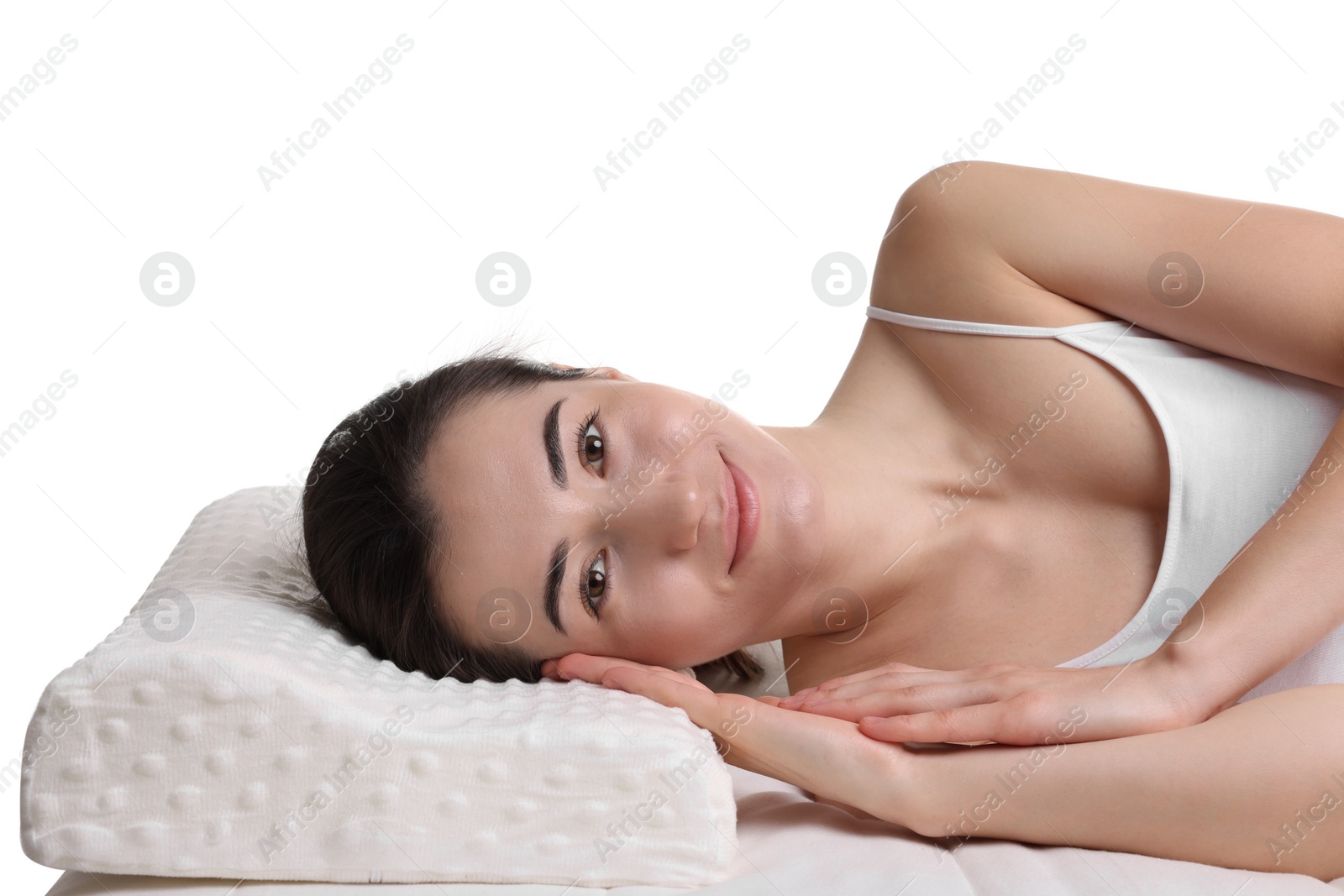 Photo of Woman lying on orthopedic pillow against white background