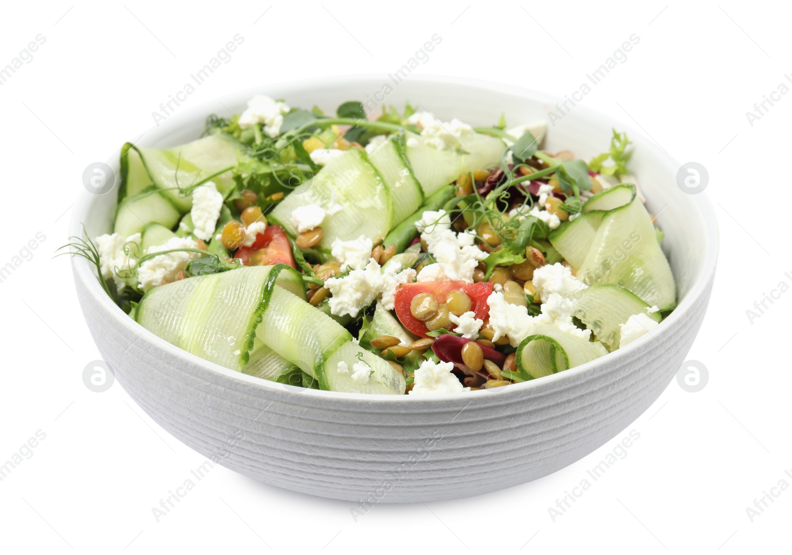 Photo of Bowl of delicious salad with lentils, vegetables and feta cheese isolated on white