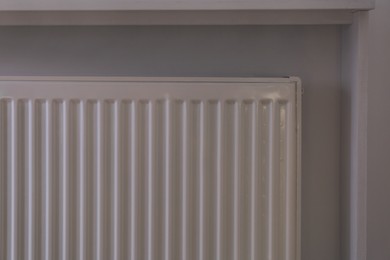 Photo of Closeup view of modern panel radiator indoors