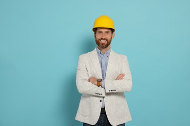 Photo of Professional engineer in hat on light blue background
