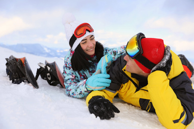 Lovely couple on snowy hill. Winter vacation