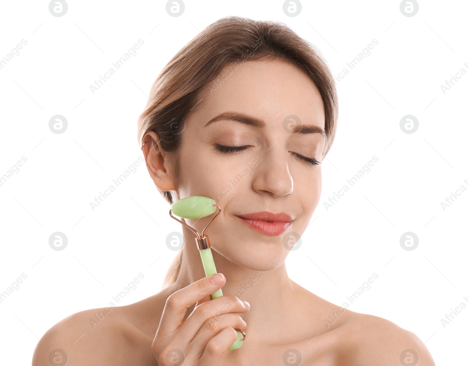 Photo of Young woman using natural jade face roller on white background